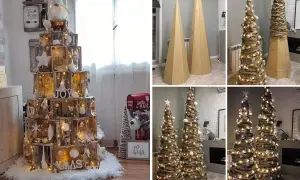 Albero di Natale fai da te con cassette di legno e alberi decorati con carta e luci.