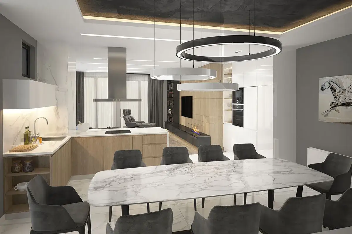 Modern dining room and kitchen with marble table, grey chairs, and three circular pendant lights.